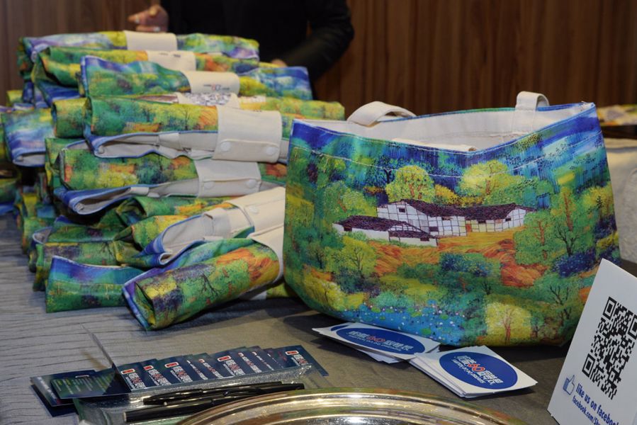 信興集團以聽障人士高楠先生的畫作，印製成精美的布袋，作為紀念品送給每位嘉賓。